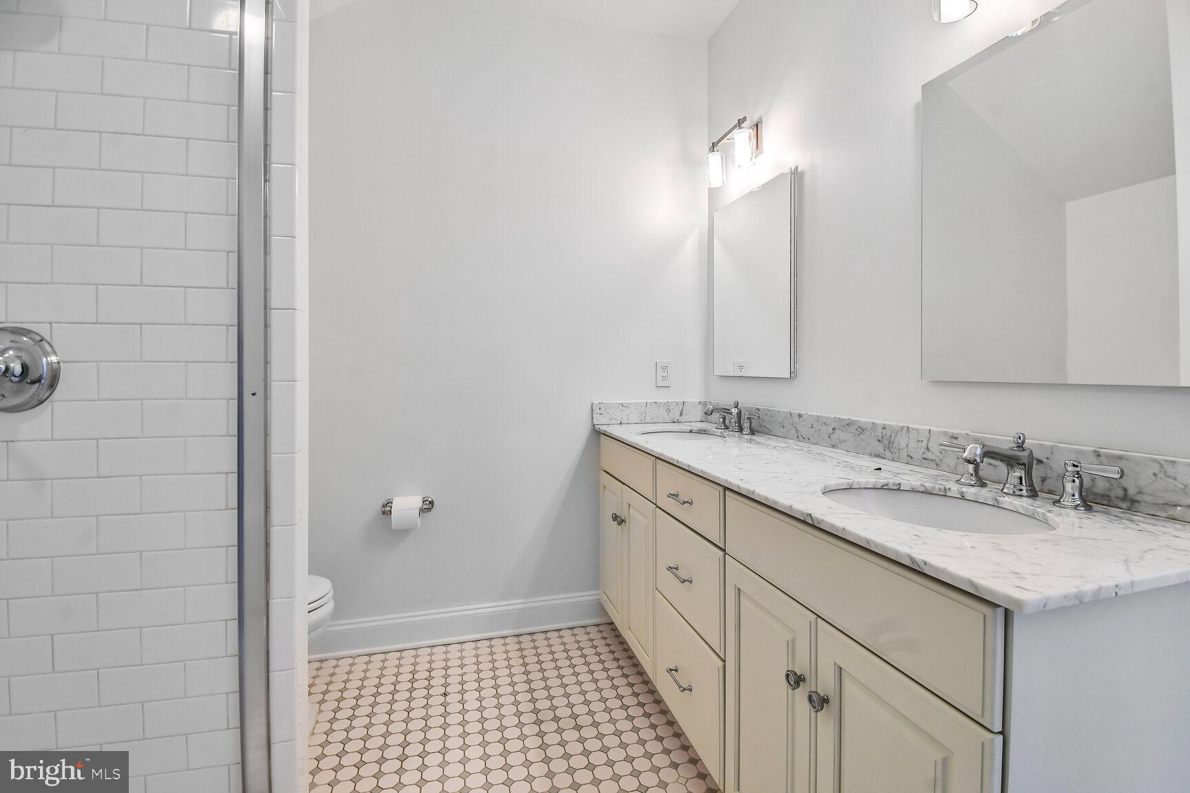 1935 Foxview Circle Northwest Washington, DC 20007 - Photo 37 of 52 a bathroom with a double vanity sink and a mirror