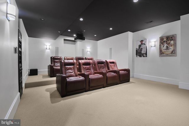a living room with couches and kitchen view