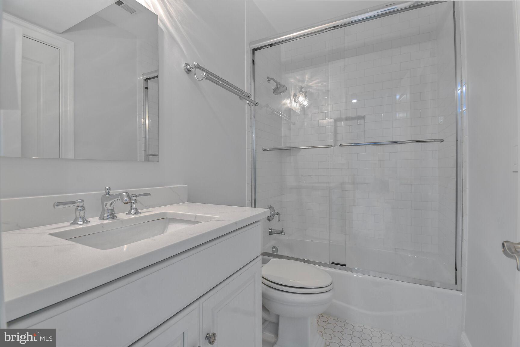 1935 Foxview Circle Northwest Washington, DC 20007 - Photo 41 of 52 a bathroom with a sink a toilet and shower