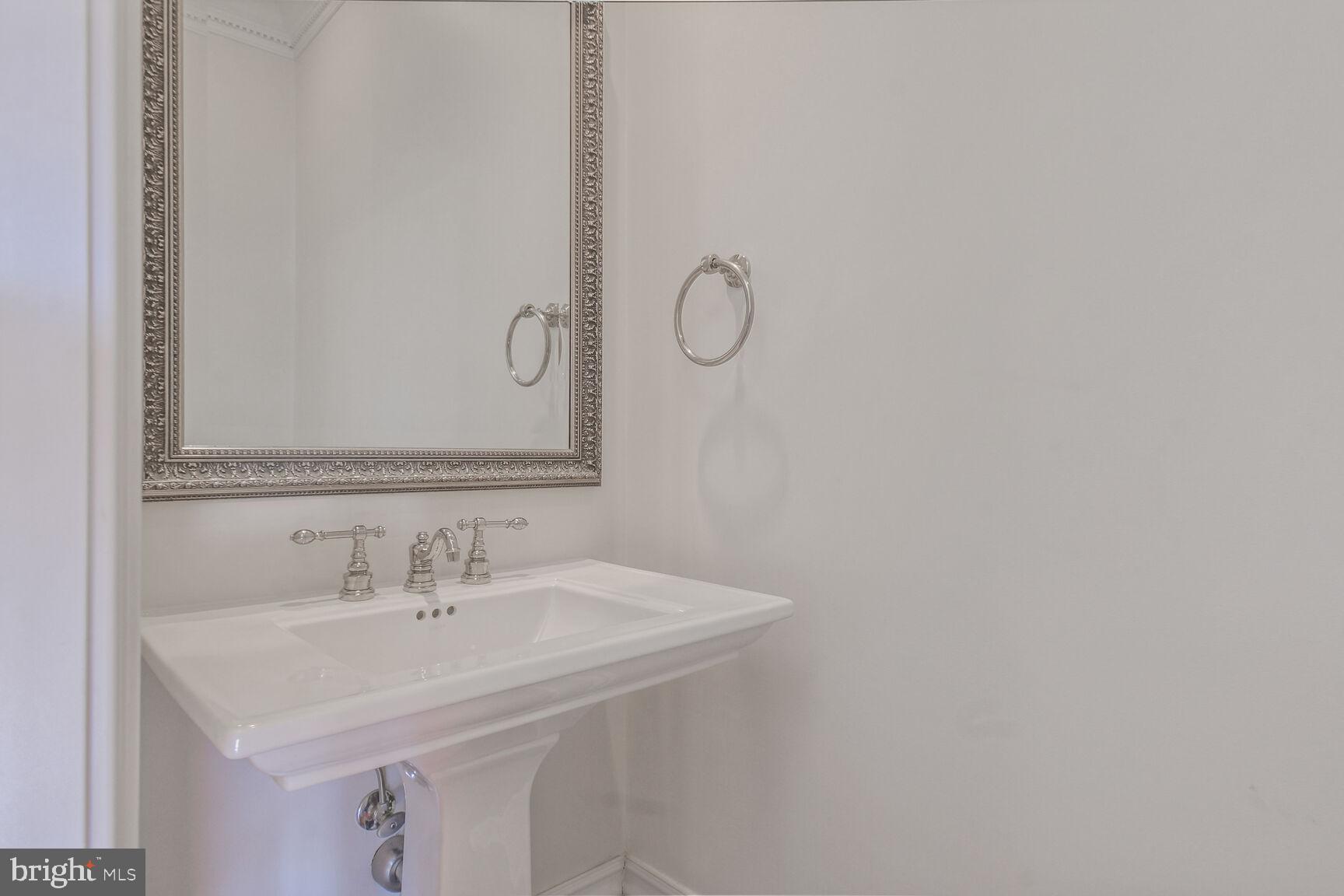 1935 Foxview Circle Northwest Washington, DC 20007 - Photo 8 of 52 a bathroom with a sink and a mirror