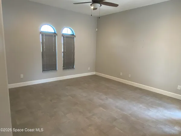 a living room with furniture a chandelier and a window