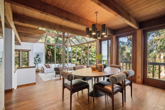 a view of a dining room with furniture window and wooden floor