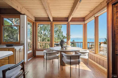 a kitchen with stainless steel appliances granite countertop a sink and wooden floors