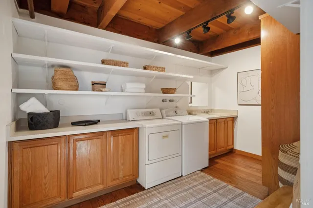 a utility room with sink dryer and washer