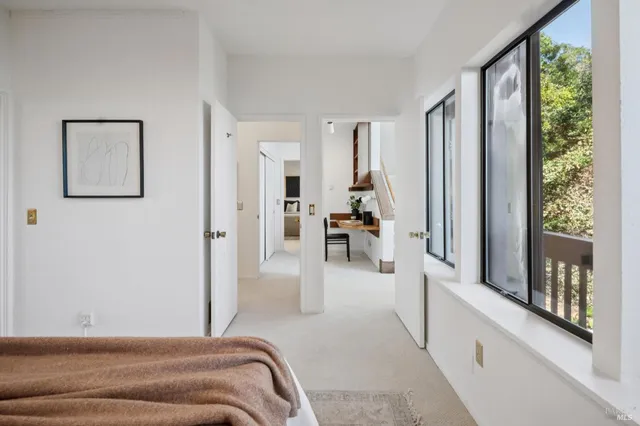 a bedroom with a bed and a large window