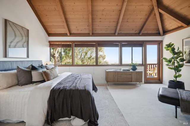 a bedroom with bed and a chandelier