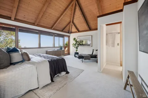 a bedroom with a large bed and a large window