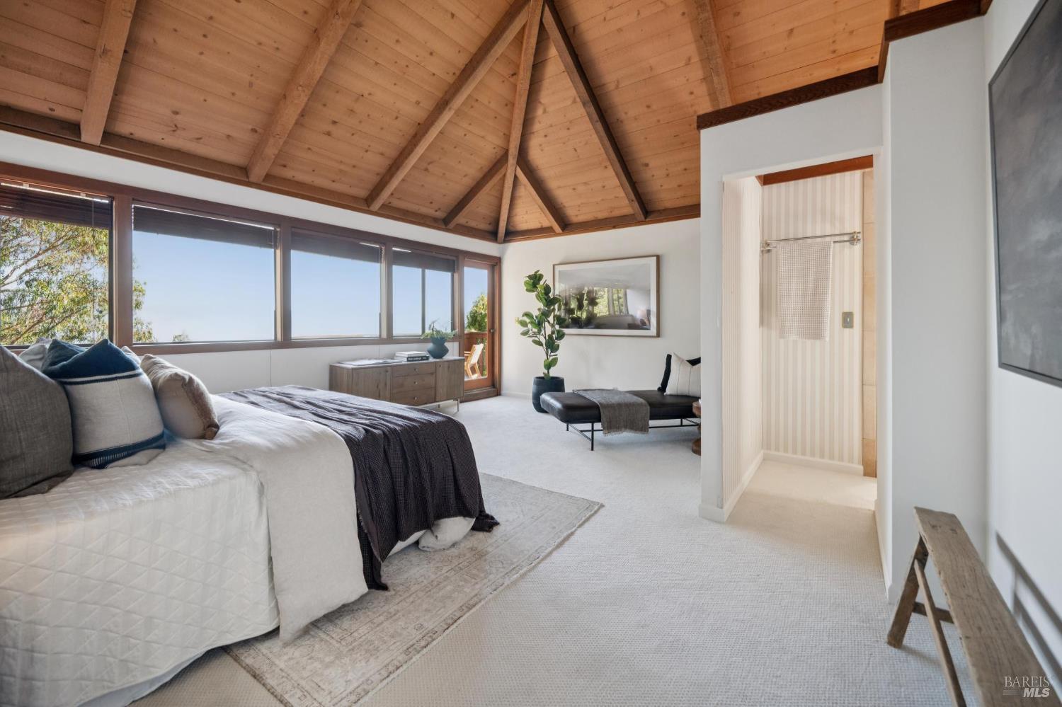 2490 Spanish Trail Road Tiburon, CA 94920 - Photo 19 of 32 a bedroom with bed and a chandelier