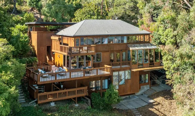a view of a house with pool and chairs