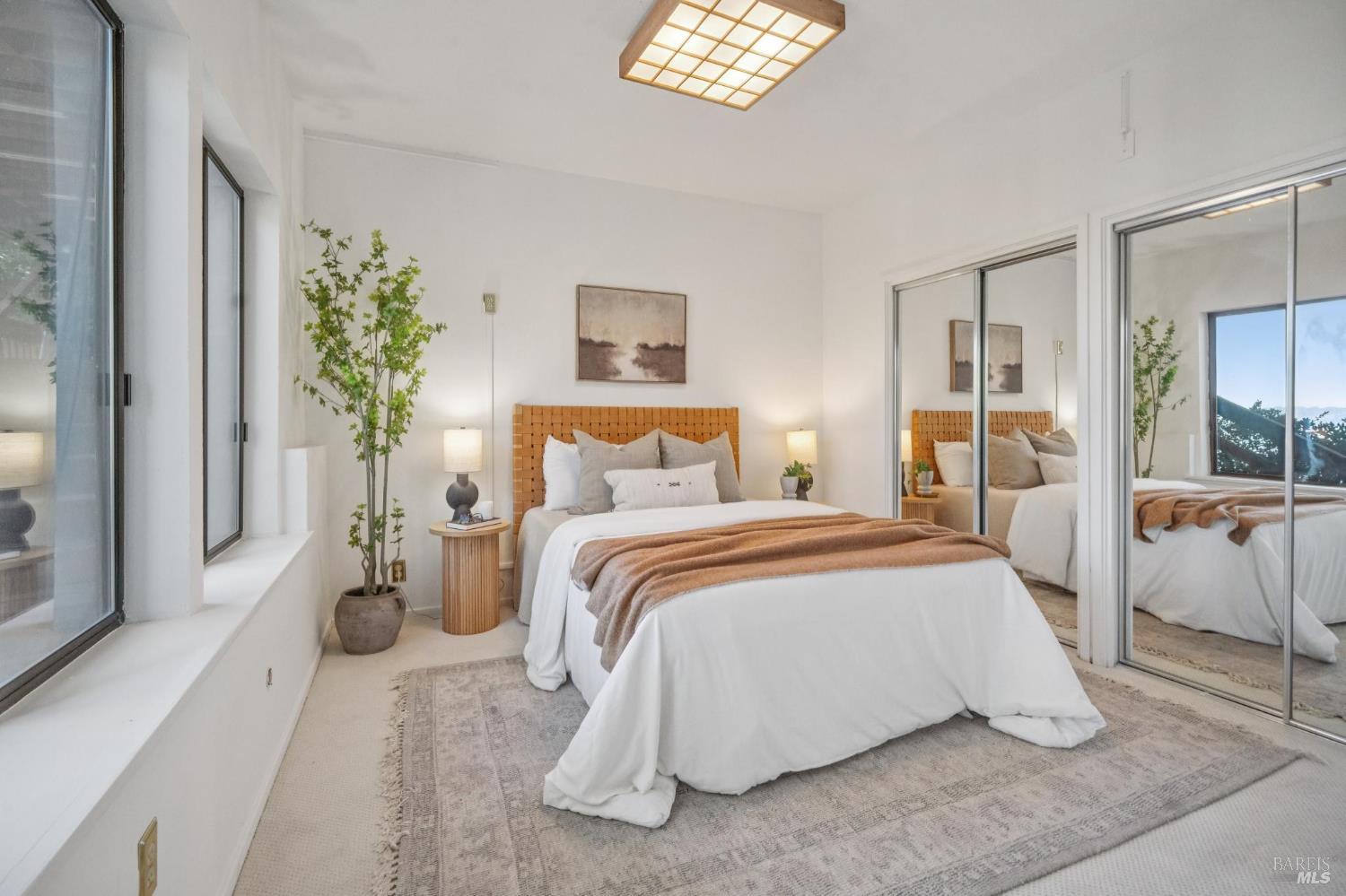 2490 Spanish Trail Road Tiburon, CA 94920 - Photo 23 of 32 a bedroom with a large bed and a chandelier