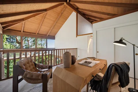 a bedroom with a large bed and a large window