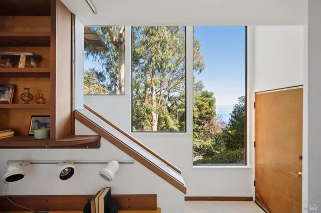 view of hall way with furniture and front door