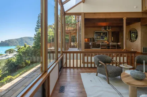 a balcony with wooden floor and outdoor seating