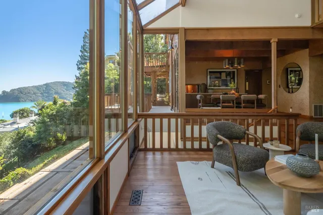 a balcony with wooden floor and outdoor seating