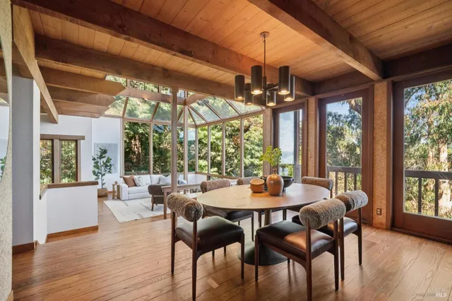 a view of a dining room with furniture wooden floor and chandelier