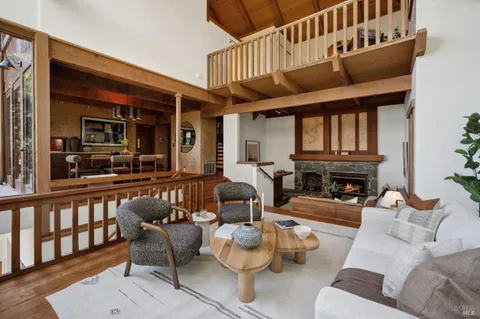 a living room with furniture a fireplace and a large window