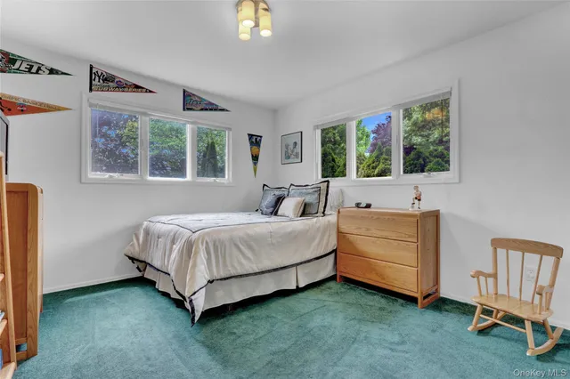 a spacious bedroom with a bed and a window