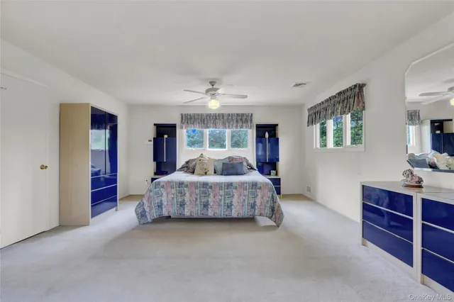 a living room with furniture and a dresser