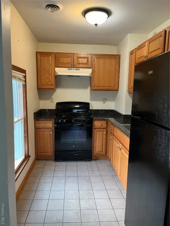 a kitchen with a refrigerator and a sink