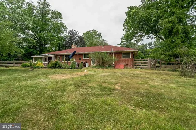 a front view of house with yard and green space