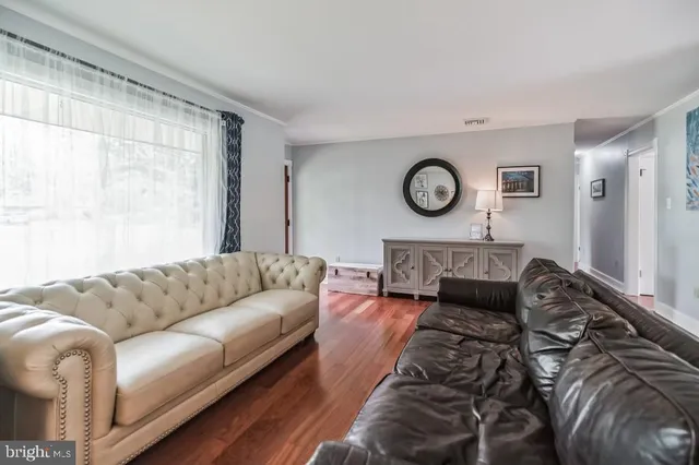 a living room with furniture a rug and a large window