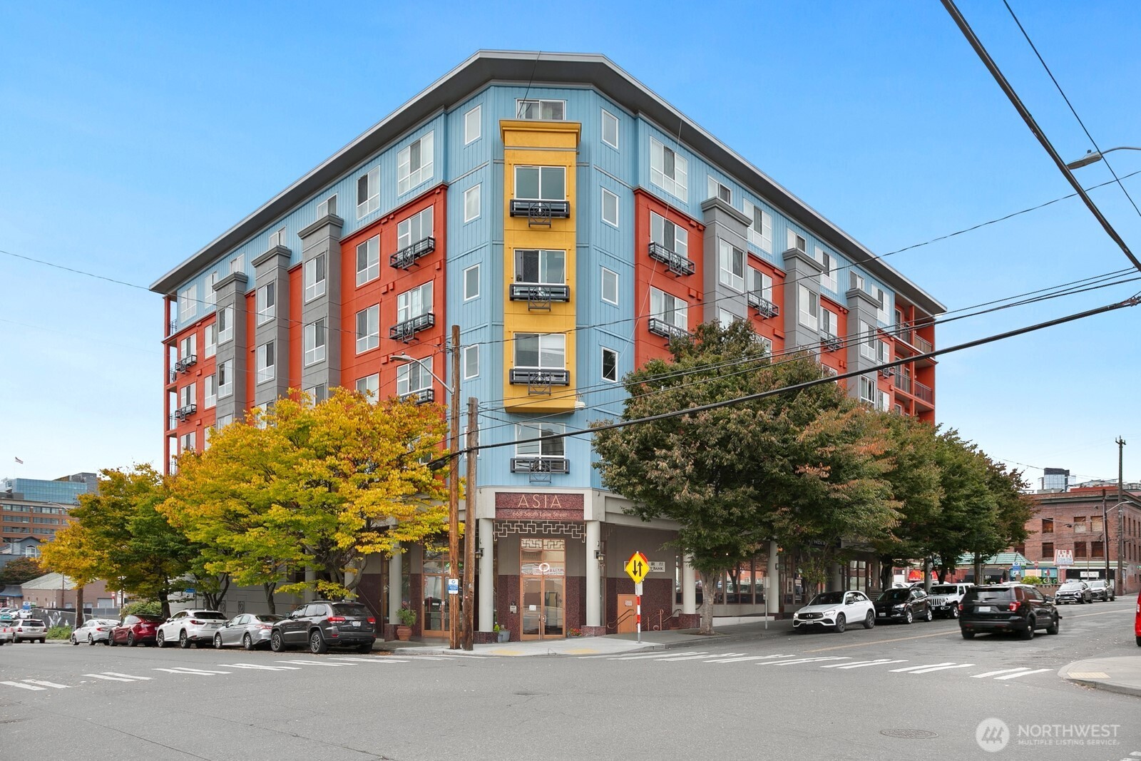 a couple of cars parked in front of a building