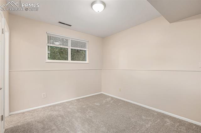4514 Ridgeglen Road Colorado Springs, CO 80918 - Photo 21 of 29 Spare bedroom featuring newly carpeted floors