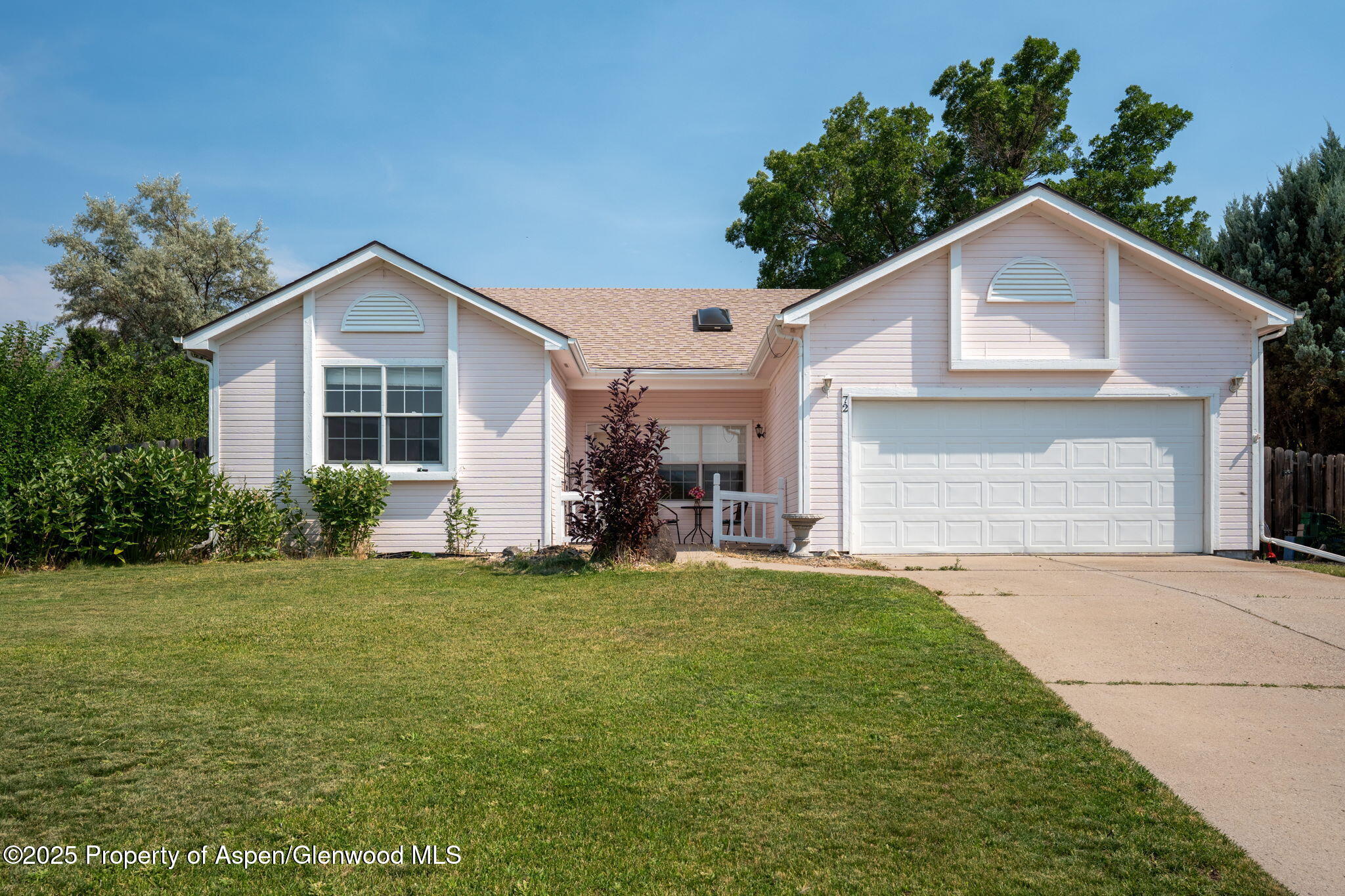 a view of a house with a yard and garage