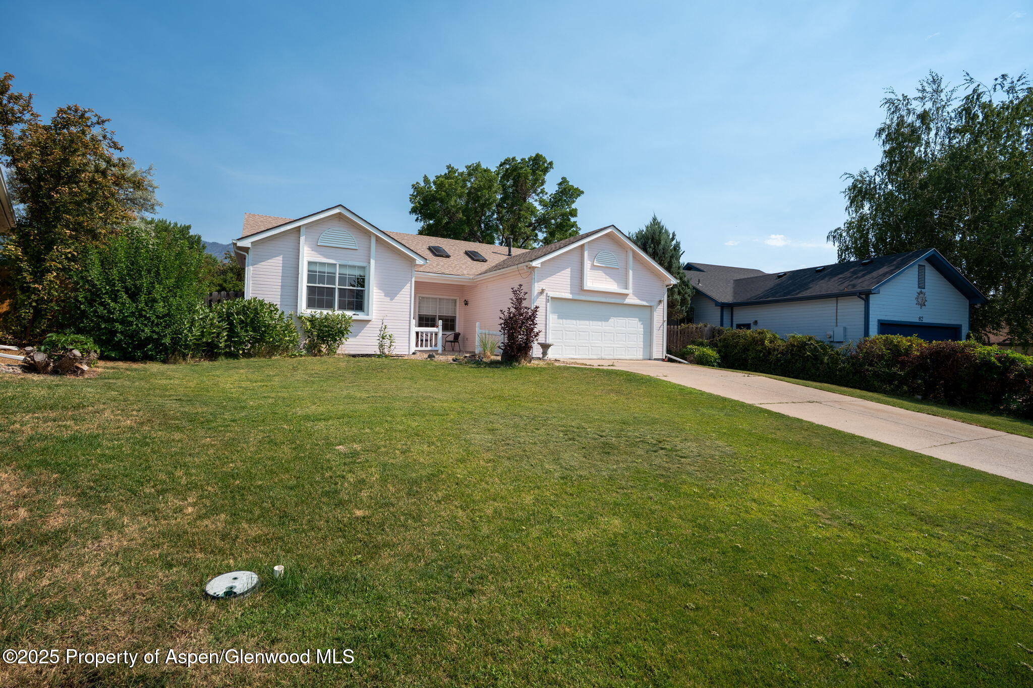 72 Juniper Lane Battlement Mesa, CO 81635 - Photo 21 of 23 a front view of a house with a yard and garage