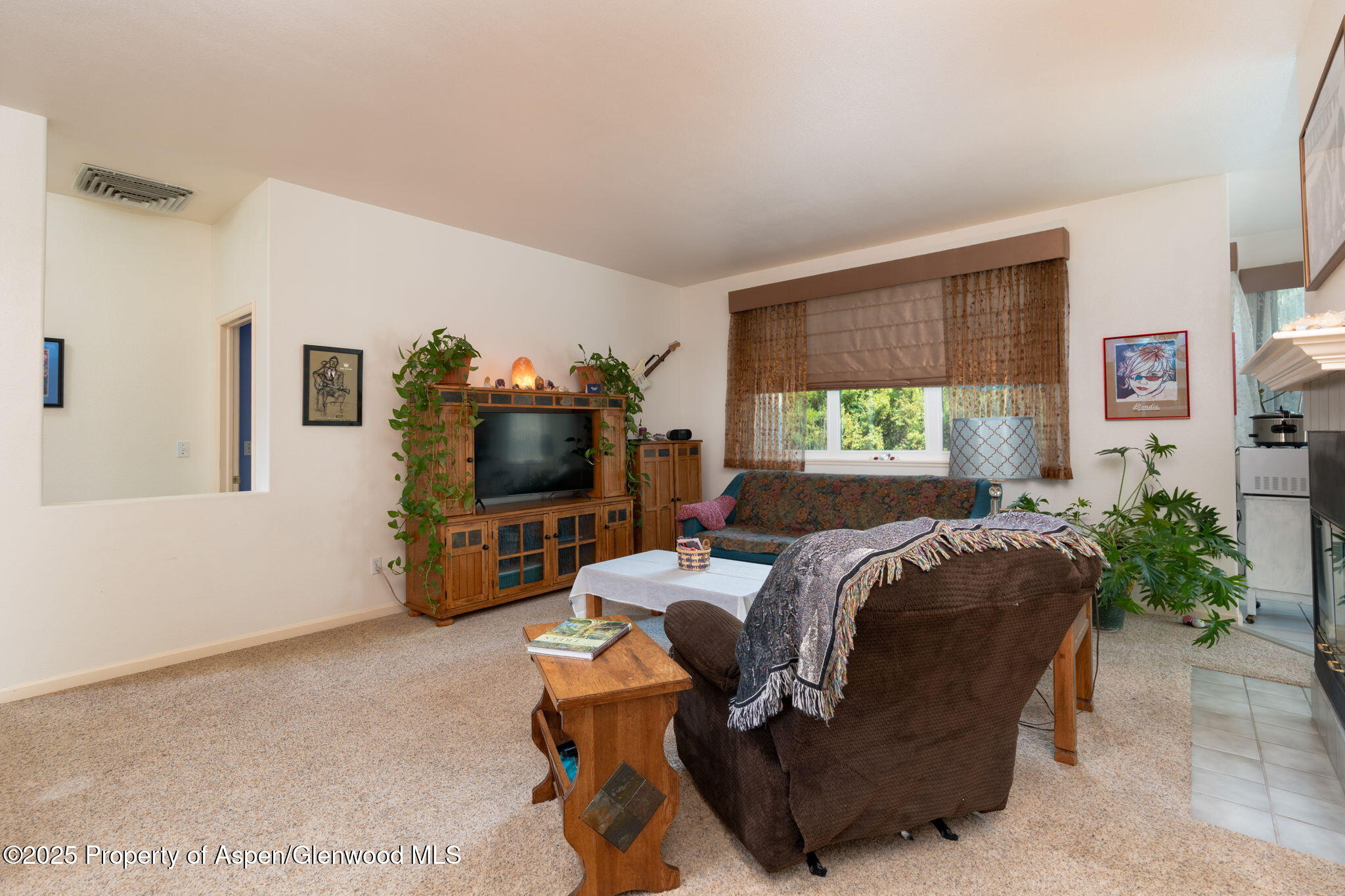 72 Juniper Lane Battlement Mesa, CO 81635 - Photo 4 of 23 a living room with furniture a flat screen tv and a large window