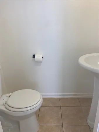 a white toilet sitting next to a white sink