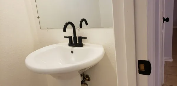 a close view of a sink and a mirror gate