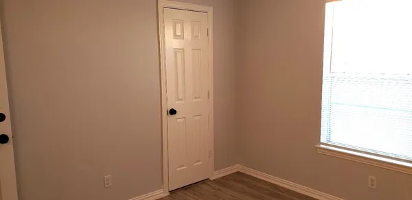 a view of front door with wooden floor