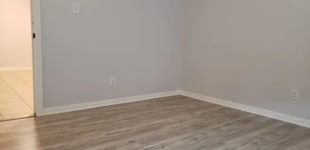 a view of an empty room with a window and a fan