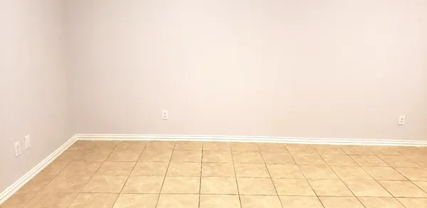 an empty room with wooden floor and a window