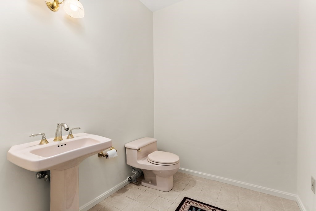26 Fox Run Road Sudbury, MA 01776 - Photo 16 of 42 a bathroom with a sink a toilet and mirror