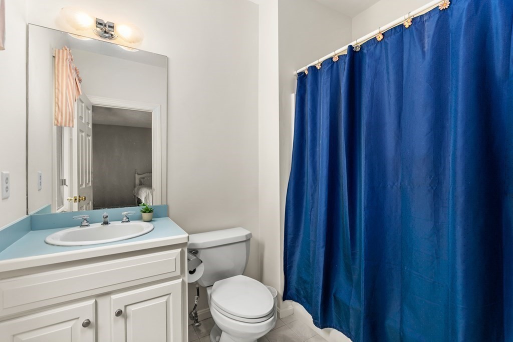 26 Fox Run Road Sudbury, MA 01776 - Photo 19 of 42 a bathroom with a sink a toilet a mirror and shower curtain