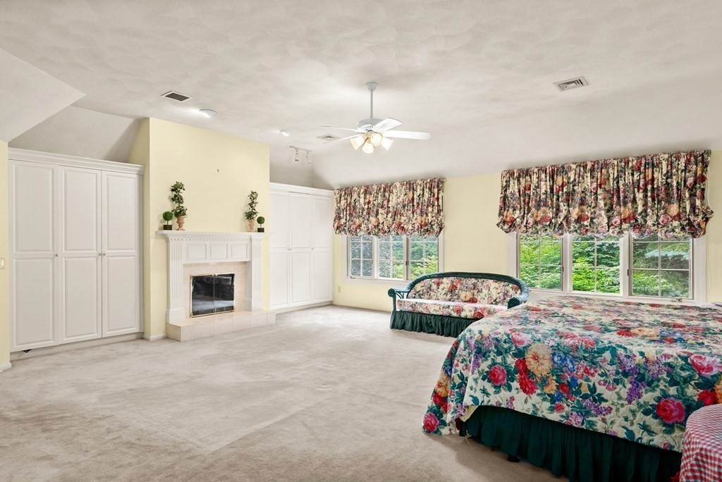 26 Fox Run Road Sudbury, MA 01776 - Photo 22 of 42 a bedroom with a bed and a fireplace