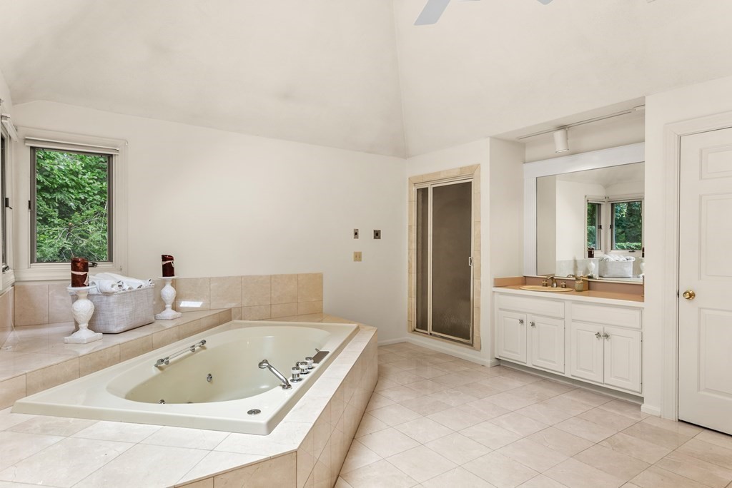 26 Fox Run Road Sudbury, MA 01776 - Photo 24 of 42 a bathroom with a tub a sink and a large mirror