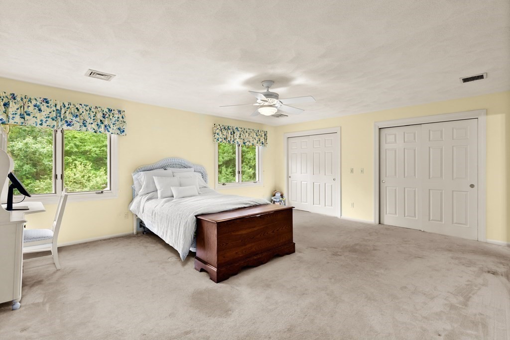 26 Fox Run Road Sudbury, MA 01776 - Photo 26 of 42 a spacious bedroom with a bed and large windows
