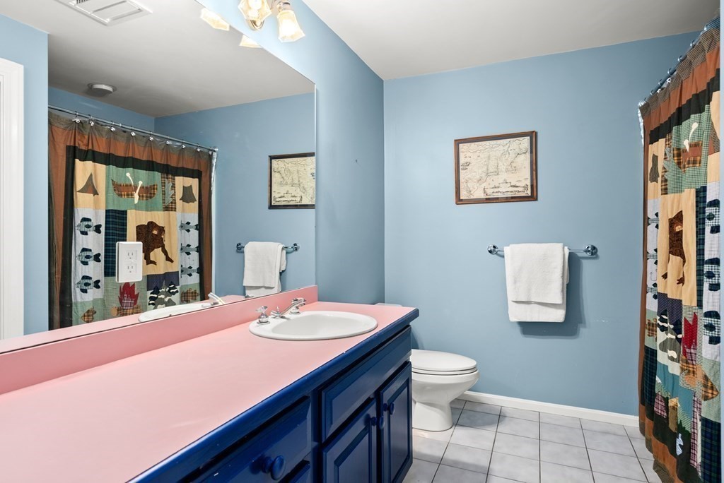 26 Fox Run Road Sudbury, MA 01776 - Photo 29 of 42 a bathroom with a sink a toilet and a mirror