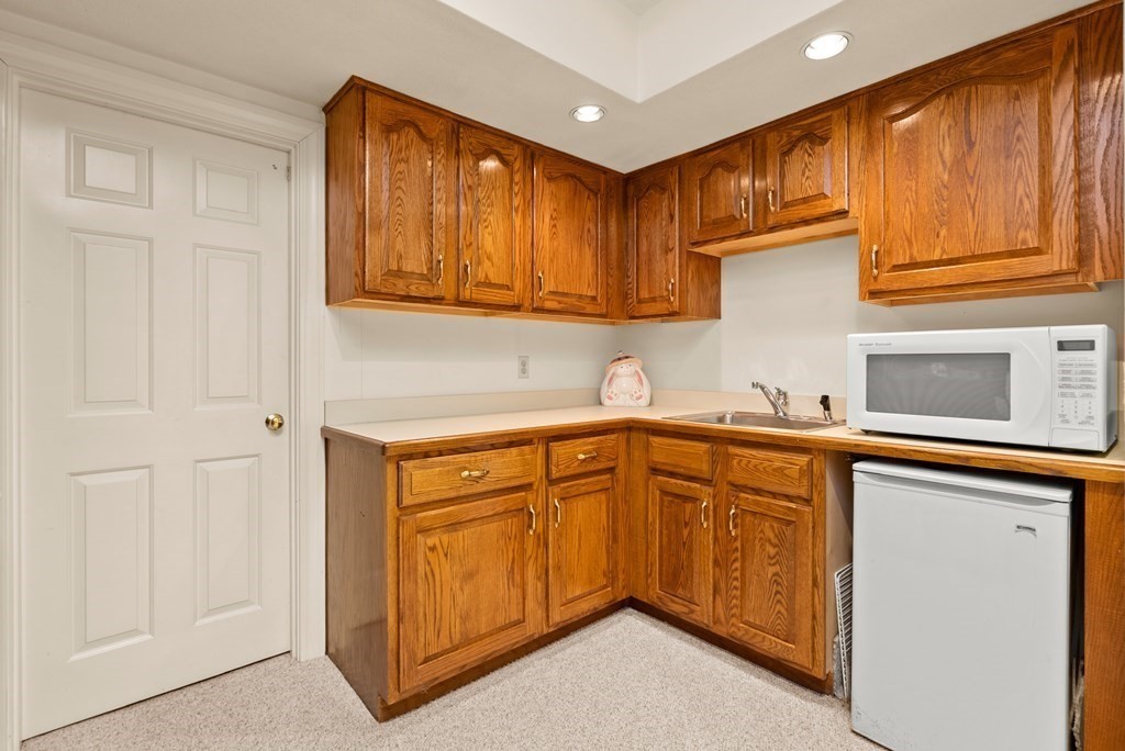 26 Fox Run Road Sudbury, MA 01776 - Photo 32 of 42 a kitchen with granite countertop cabinets stainless steel appliances a sink and wooden floor