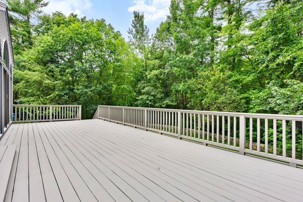 26 Fox Run Road Sudbury, MA 01776 - Photo 35 of 42 a balcony with wooden floor and trees in the background
