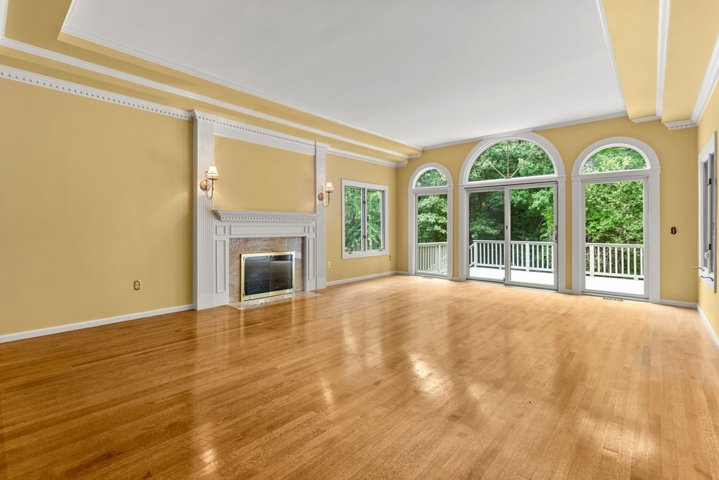 26 Fox Run Road Sudbury, MA 01776 - Photo 6 of 42 a view of an empty room with a window and a fireplace
