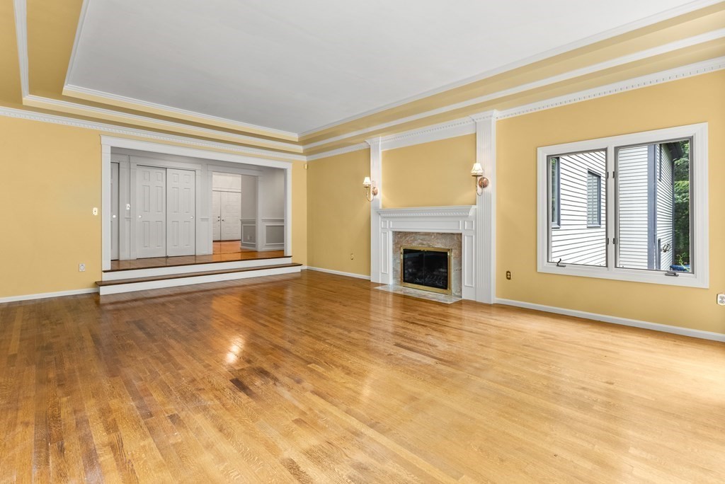 26 Fox Run Road Sudbury, MA 01776 - Photo 7 of 42 a view of an empty room with a fireplace and a window