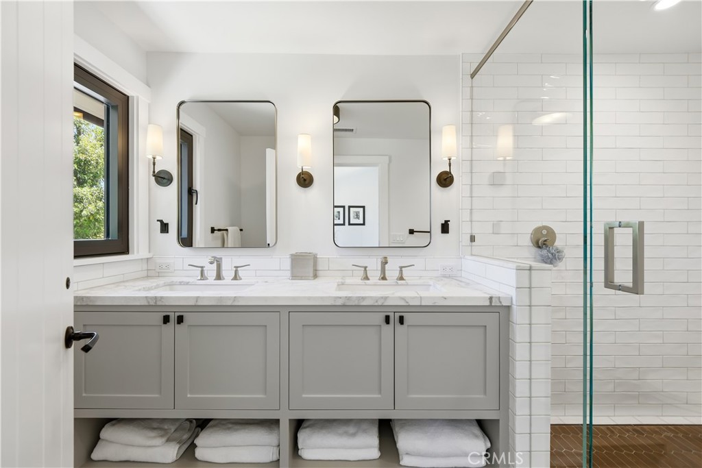 24884 Jim Bridger Road Hidden Hills, CA 91302 - Photo 21 of 31 a bathroom with a double vanity sink and mirror
