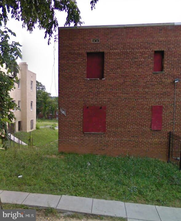 a brick building with a small yard