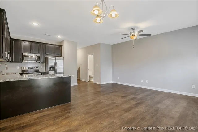 a view of kitchen with sink microwave and cabinets