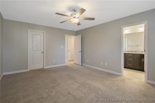 a view of an empty room with a ceiling fan