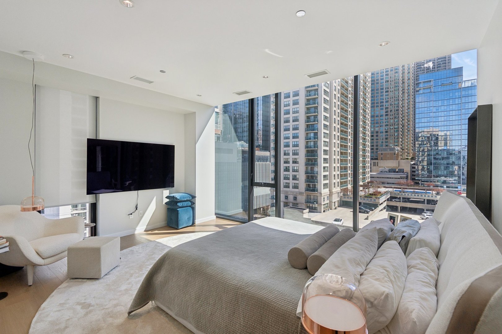 56 West Huron Street, Unit 9 Chicago, IL 60654 - Photo 22 of 38 a bedroom with a bed and a flat screen tv